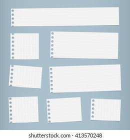 Pieces of cut white squared, lined notebook paper are stuck on blue background