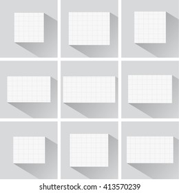 Pieces of cut white squared notebook paper with long shadow are stuck on blue background