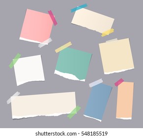 Pieces of different size colorful note, notebook, copybook paper sheets stuck with sticky tape on gray background