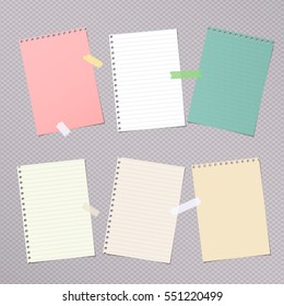 Pieces of different size colorful note, notebook, copybook paper sheets stuck with sticky tape on gray background