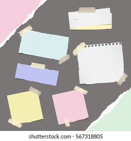 Pieces of different size colorful note, notebook, copybook paper sheets stuck with sticky tape on gray background