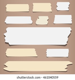 Pieces of different size sticky, masking tape are on brown background