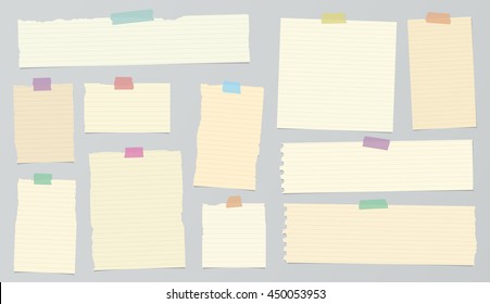 Pieces of light brown ruled torn note paper with colorful adhesive, sticky tape.