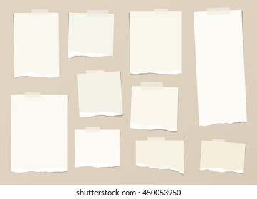 Pieces of light brown torn note paper with adhesive, sticky tape are stuck on background