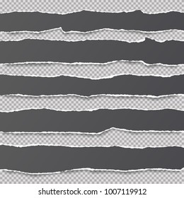 Pieces of ripped black blank note, notebook paper strips stuck on gray squared background