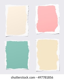 Pieces of ripped colorful blank notebook paper stuck on gray background