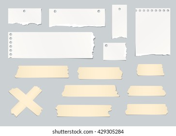 Pieces of ripped white blank note paper, masking tapes are stuck on gray background.