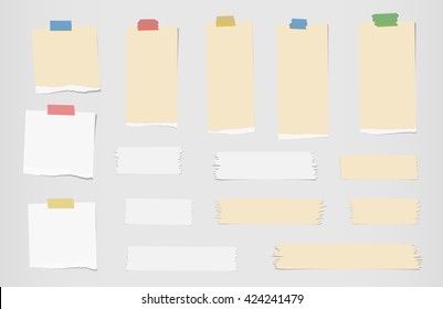 Pieces of ripped white, brown blank note paper, sticky, adhesive tapes are stuck on gray wall - Shutterstock ID 424241479