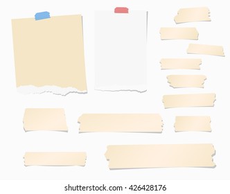 Pieces of ripped white, brown blank note paper, colorful sticky, adhesive tapes are stuck on wall