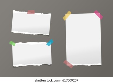 Pieces of ripped white note, card, notebook, copybook paper sheets stuck with colorful sticky tape on gray background