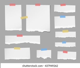 Pieces of ripped white note paper are stuck with masking tapes on gray background