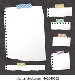 Pieces of ripped white notebook paper are stuck with sticky tape on black pattern.
