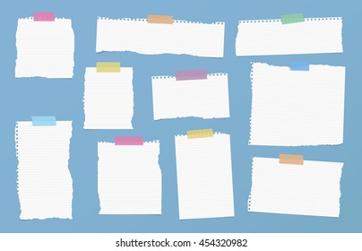 Pieces of ripped white ruled note paper are stuck with colorful sticky tapes on blue background
