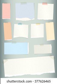 Pieces of torn colorful blank note paper on gray background