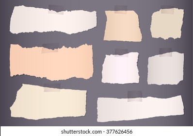 Pieces of torn colorful blank paper on dark background