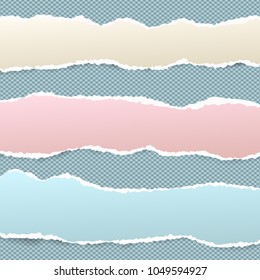 Pieces of torn colorful note, notebook paper strips stuck on blue squared background
