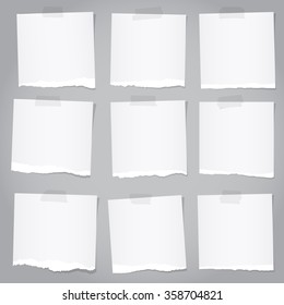 Pieces of torn gray note paper with adhesive tape