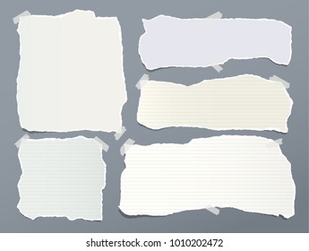 Pieces of torn green, yellow, white note, notebook paper strips stuck with sticky tape on gray background