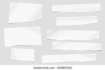 Pieces of torn white blank note, notebook paper for text stuck on striped gray background.
