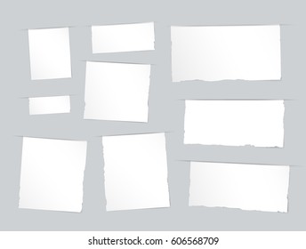 Pieces of torn white blank, note, copybook, notebook strips, sheets inserted into gray cut paper
