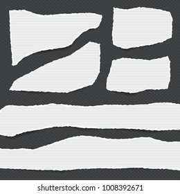 Pieces of torn white lined note, notebook paper strips stuck on black squared background