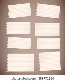 Pieces of torn white lined note paper on brown background
