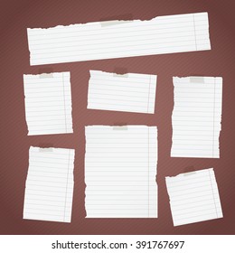 Pieces of torn white lined note paper with sticky tape on diagonal dark background