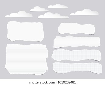 Pieces of torn white lined, squared blank note, notebook paper strips with clouds on gray background