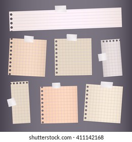 Pieces of torn white lined, squared notebook paper are stuck on gray background