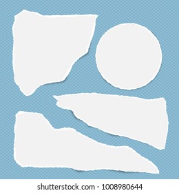 Pieces of torn white note, notebook paper stuck on blue squared background