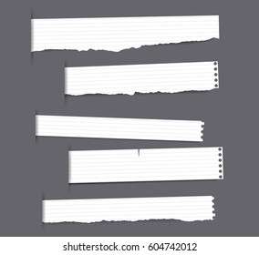 Pieces of torn white note paper are stuck on squared grey pattern