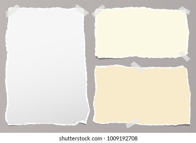 Pieces of torn white, yellow note, notebook paper sheets stuck on gray background
