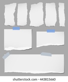 Pieces of various gray torn note paper with adhesive tape are stuck on background