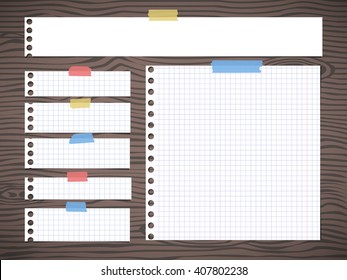 Pieces of white squared note paper is stuck on brown wooden wall or desk