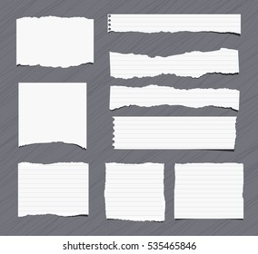 Pieces Of White Torn Note, Notebook, Copy Book Paper Sheets Stuck On Grey Background