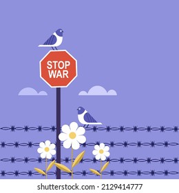 Pigeons sitting on 'Stop War' signage at a fenced international border