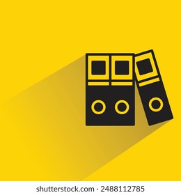 pile of books icon with shadow on yellow background