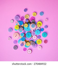 Pile of colorful sewing buttons on pink background, eps 10