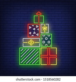 Pile of presents neon sign. Present boxes, carton wrap, ribbon, bow. Vector illustration in neon style for topics like surprise, holiday, Christmas shopping