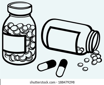 Pill bottle. Spilling pills on to surface. Isolated on blue background