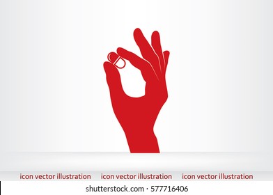 Pill in the hand icon vector illustration.