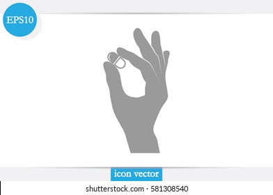 Pill in the hand icon vector illustration.