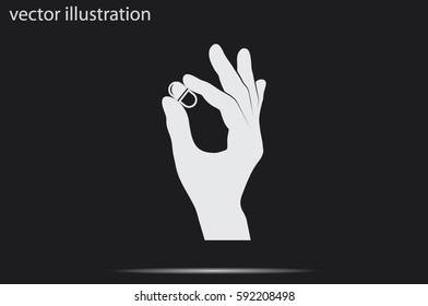 Pill in the hand icon vector illustration.