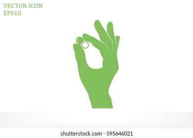 Pill in the hand icon vector illustration.