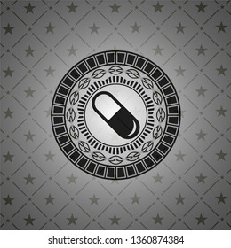 pill icon inside black emblem