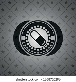 pill icon inside black emblem