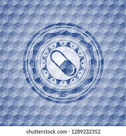 pill icon inside blue emblem or badge with geometric pattern background.