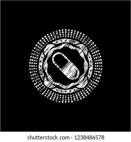 pill icon inside chalkboard emblem written on a blackboard