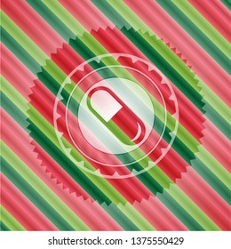 pill icon inside christmas colors style emblem.