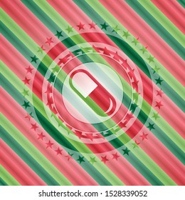 pill icon inside christmas colors style emblem.